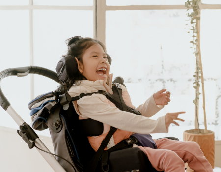 Laughing girl in a wheelchair