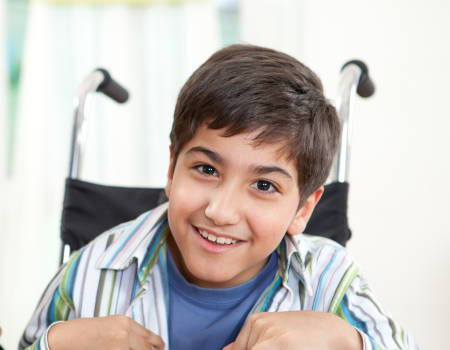 Boy smiling in a wheelchair